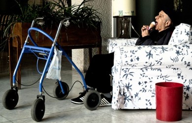 Old man with a walker eating ice cream