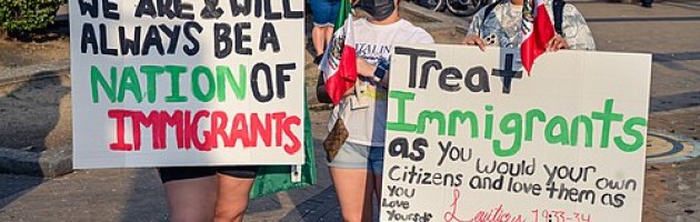 people carrying protest signs against ICE.
